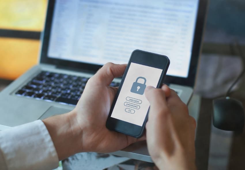 Man holding smartphone with secure login page