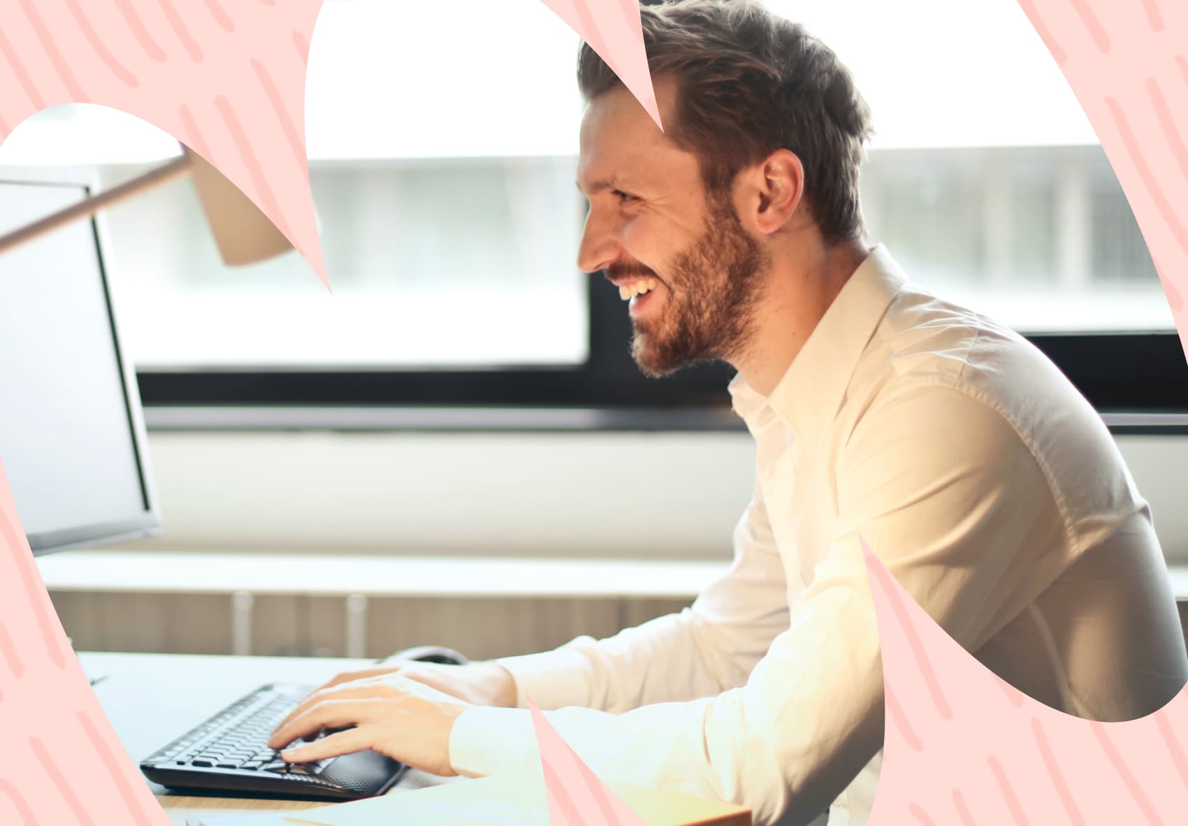Smiling man looking at computer screen