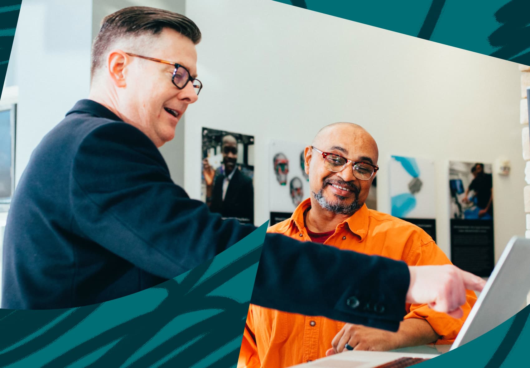 Two men standing and looking at laptop