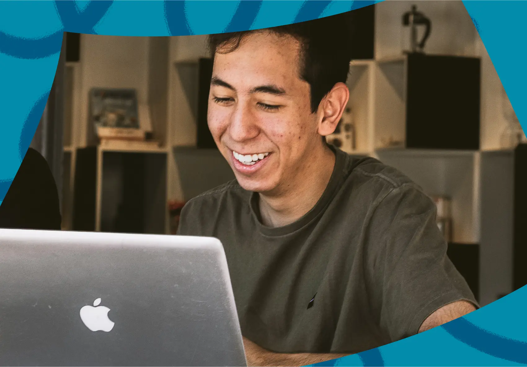 Smiling man sitting in front of a laptop
